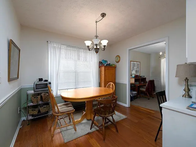 a dining room with furniture and window