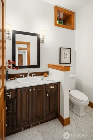 a bathroom with a toilet sink and mirror