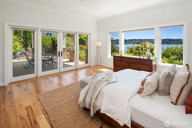 a bedroom with a bed and glass window
