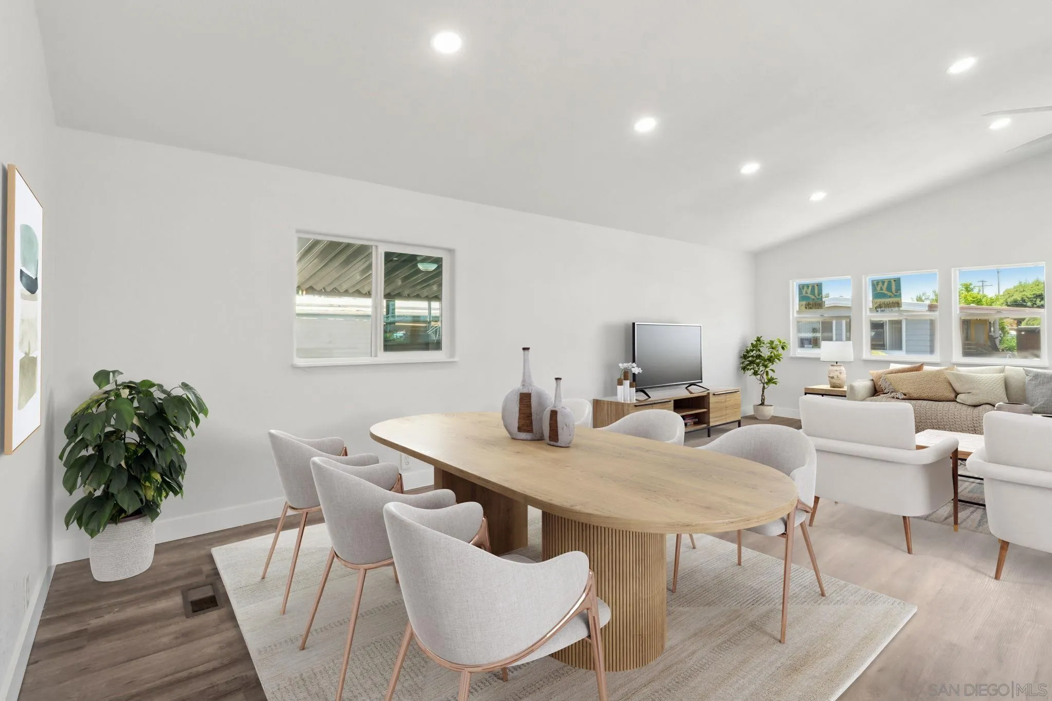 a view of a dining room with furniture and a potted plant