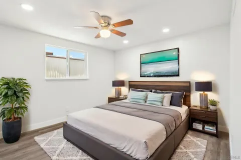 a bedroom with a large bed and a potted plant