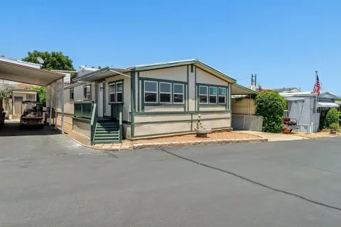 a front view of a house with a road