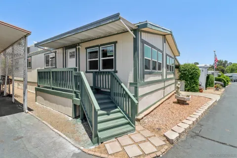 a view of backyard with deck and seating area