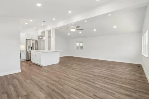 a kitchen with stainless steel appliances granite countertop a stove a sink and a microwave