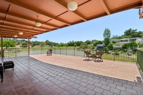 a view of a swimming pool and lounge chairs