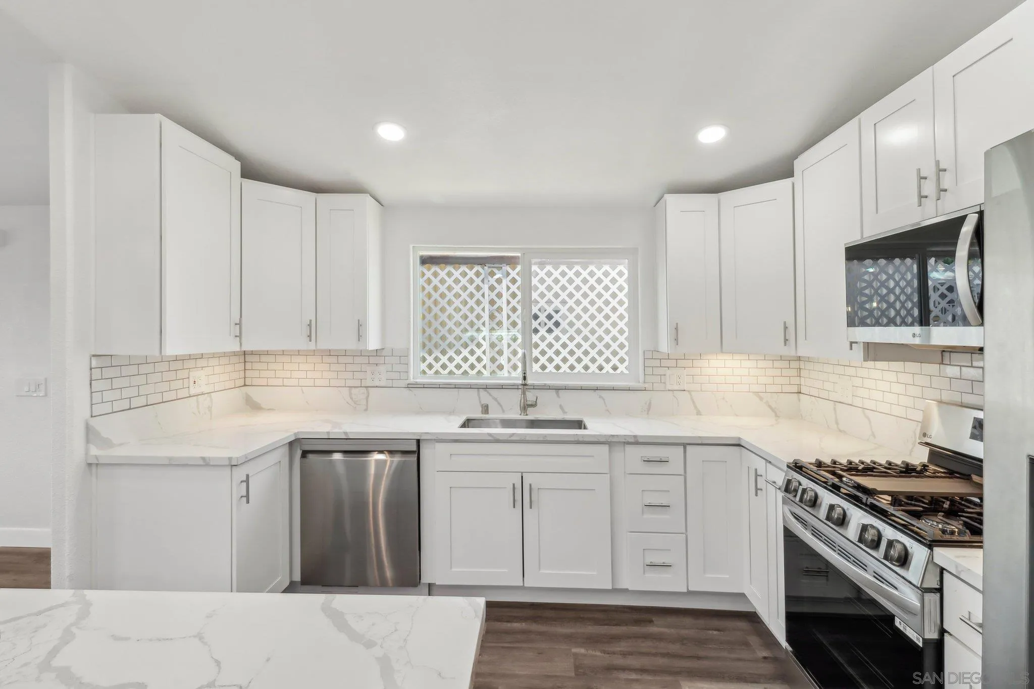 28890 Lilac Road, Unit 97 Valley Center, CA 92082 - Photo 4 of 51 a kitchen with stainless steel appliances granite countertop a stove a sink and a microwave
