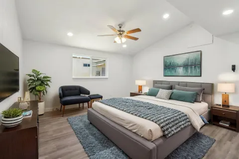 a bedroom with a bed and a couch