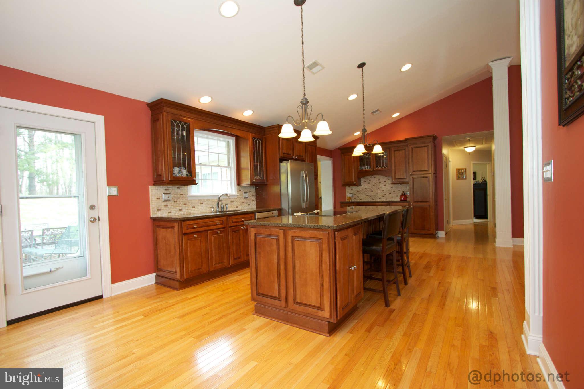 1315 Murgatroyd Road Fallston, MD 21047 - Photo 8 of 30 a kitchen with a refrigerator a sink dishwasher a dining table and chairs with wooden floor