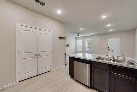 a view of a hallway with wooden floor and entryway