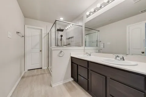 a bathroom with a glass shower door