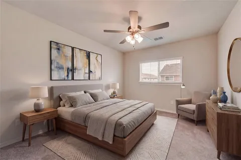 a bedroom with a bed couch and window