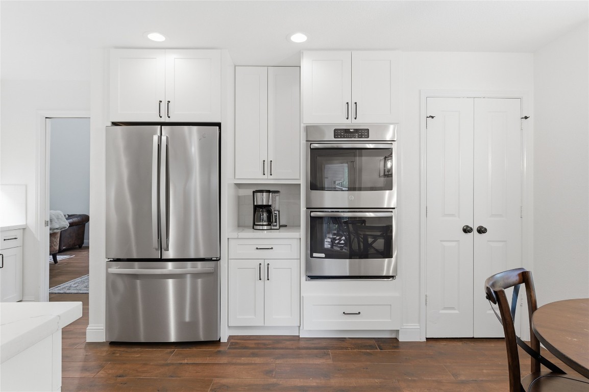 50 East Greywing Circle Spring, TX 77382 - Photo 14 of 37 Modern kitchen with sleek, white cabinetry and wooden flooring create a bright, inviting space.
