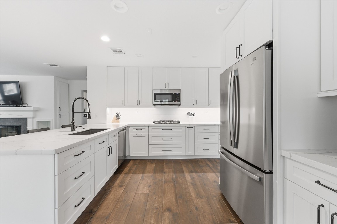 50 East Greywing Circle Spring, TX 77382 - Photo 15 of 37 This modern kitchen features a spacious island with a stylish faucet.
