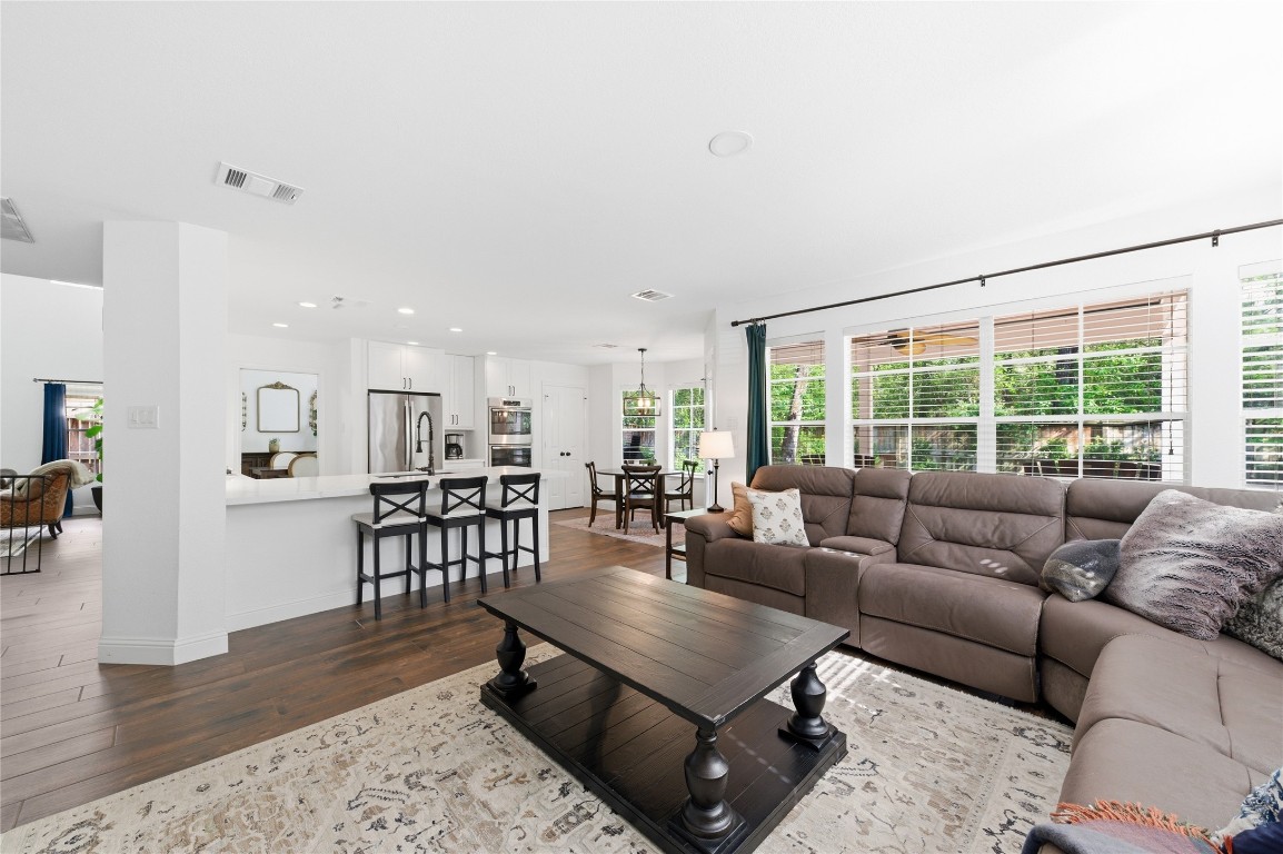 50 East Greywing Circle Spring, TX 77382 - Photo 19 of 37 Airy open-concept living space features a cozy living area. Expansive windows provide plenty of natural light and a view of the greenery outside.