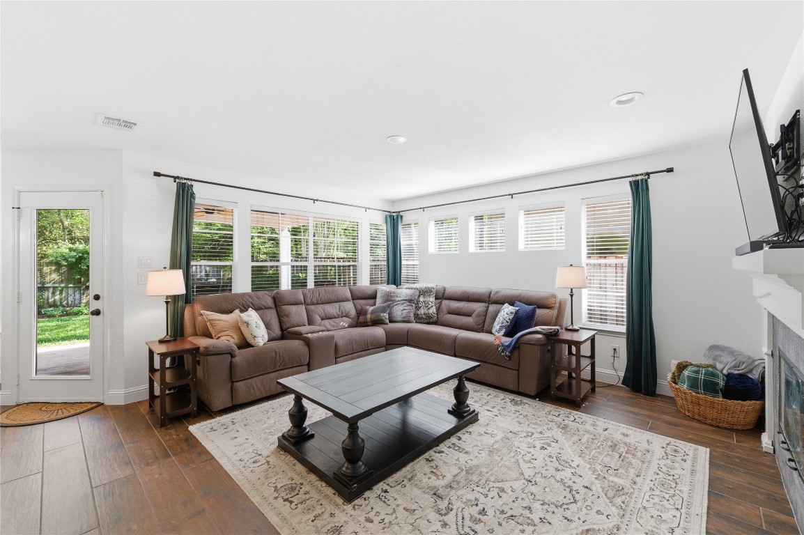 50 East Greywing Circle Spring, TX 77382 - Photo 10 of 37 Inviting living room and elegant wood flooring allows access to a lush backyard through a glass door.