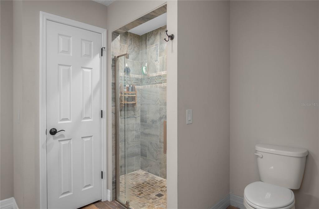 5466 West Tortuga Loop Lecanto, FL 34461 - Photo 22 of 41 a bathroom with a granite countertop toilet and a shower