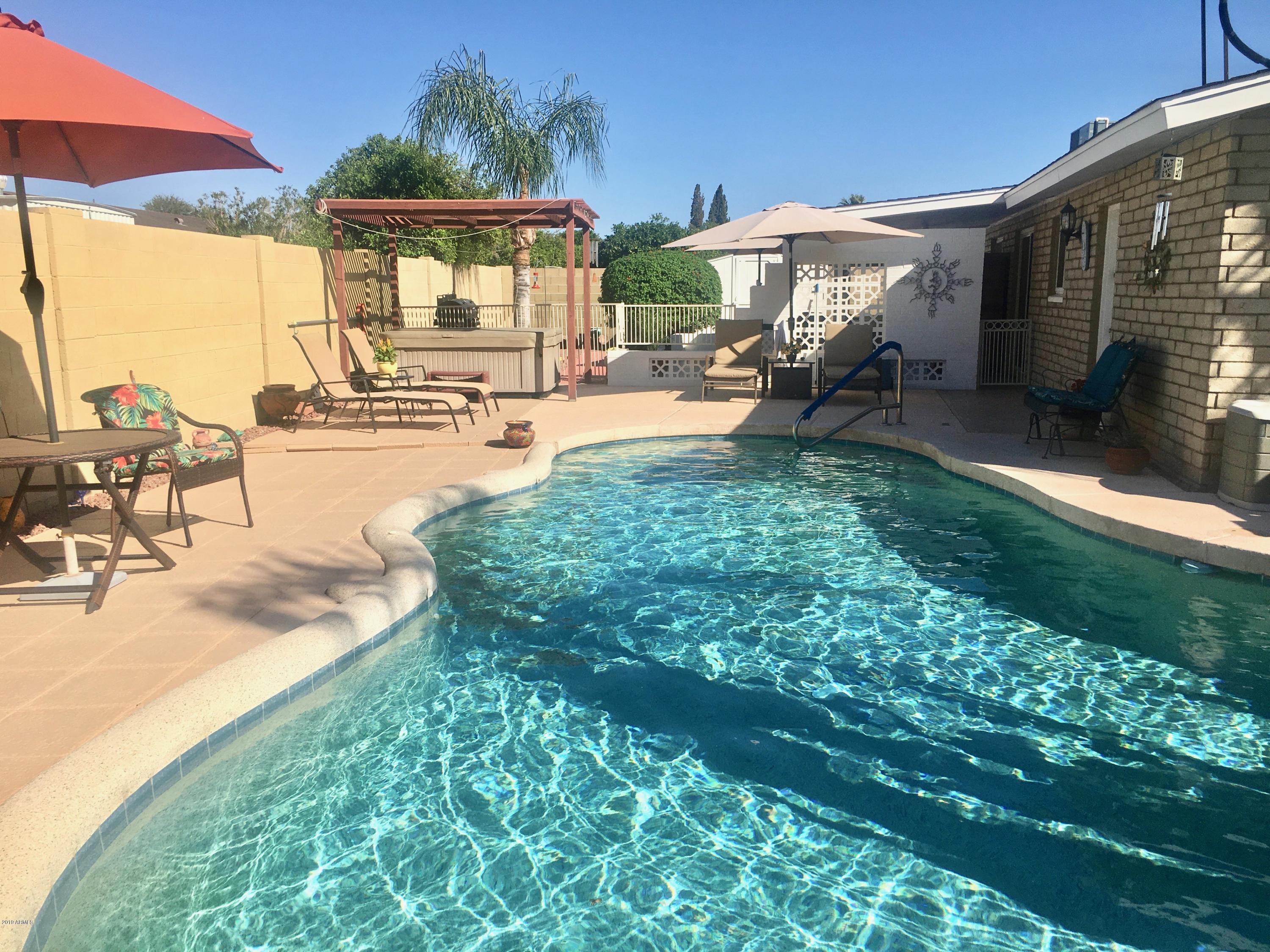 5402 East Decatur Street Mesa, AZ 85205 - Photo 28 of 37 a view of a patio with table and chairs under an umbrella