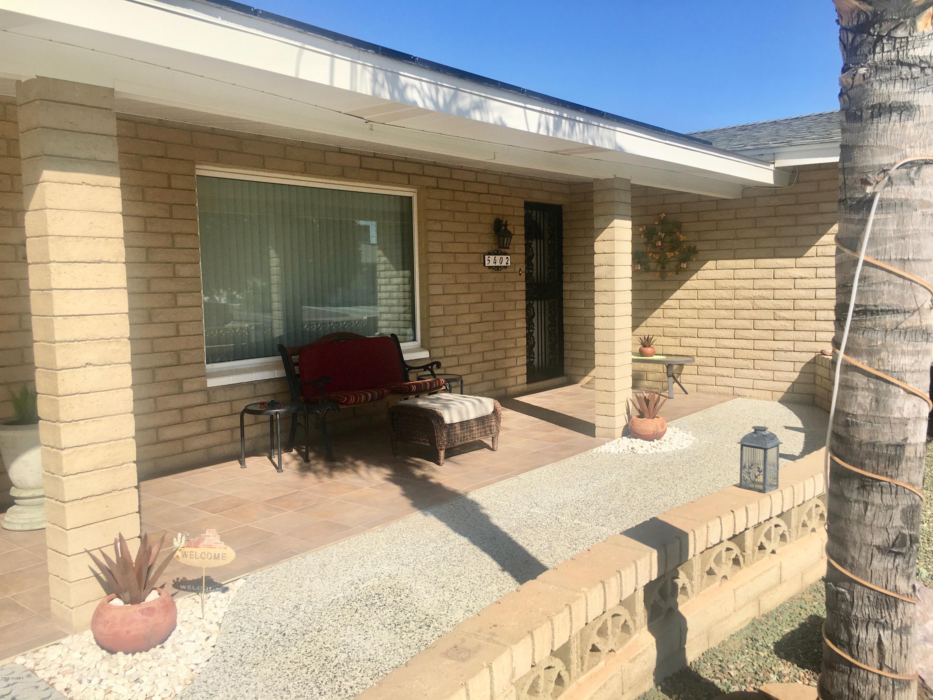 5402 East Decatur Street Mesa, AZ 85205 - Photo 5 of 37 a front view of a house with patio