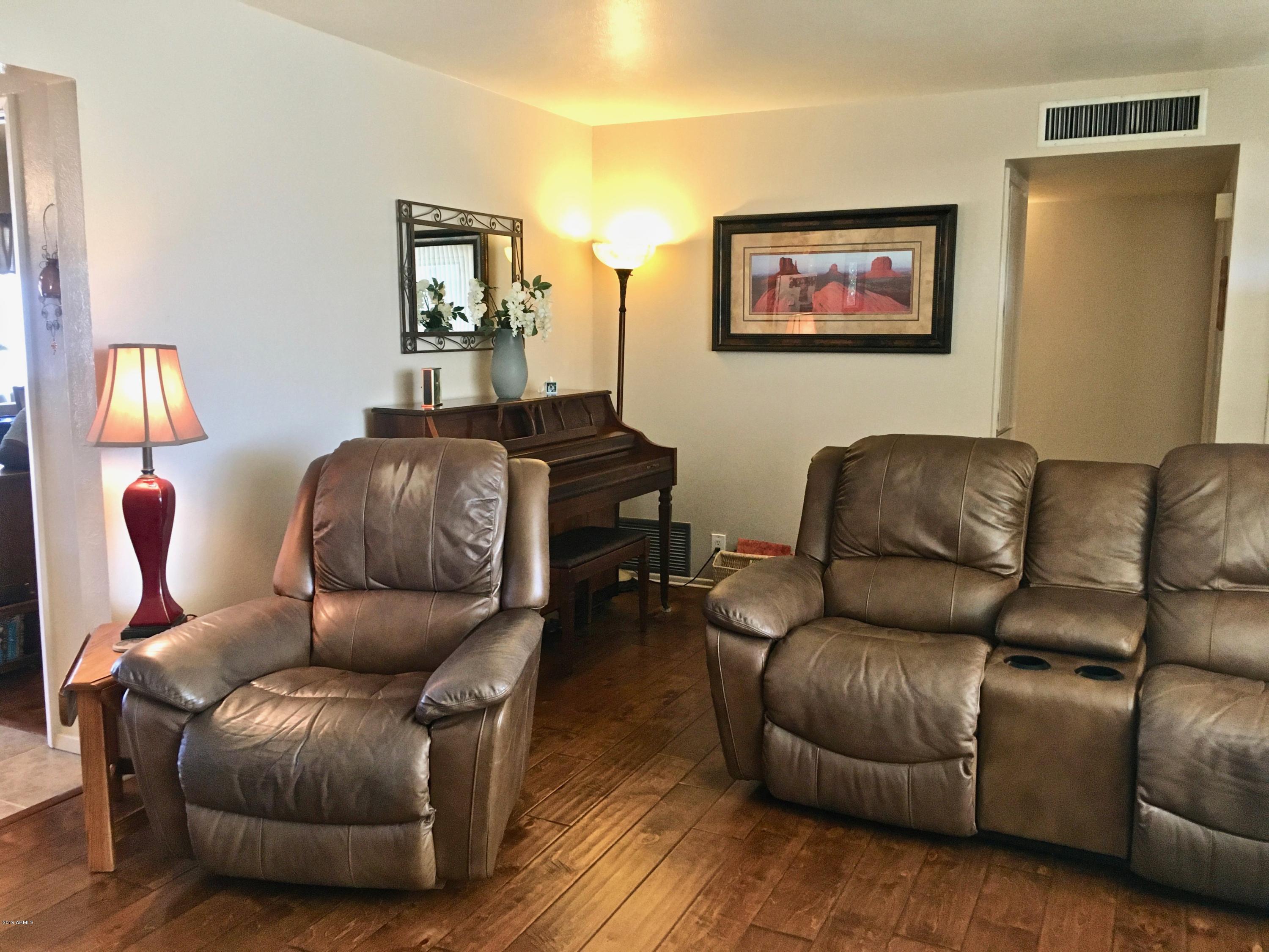 5402 East Decatur Street Mesa, AZ 85205 - Photo 7 of 37 a living room with furniture and a mirror
