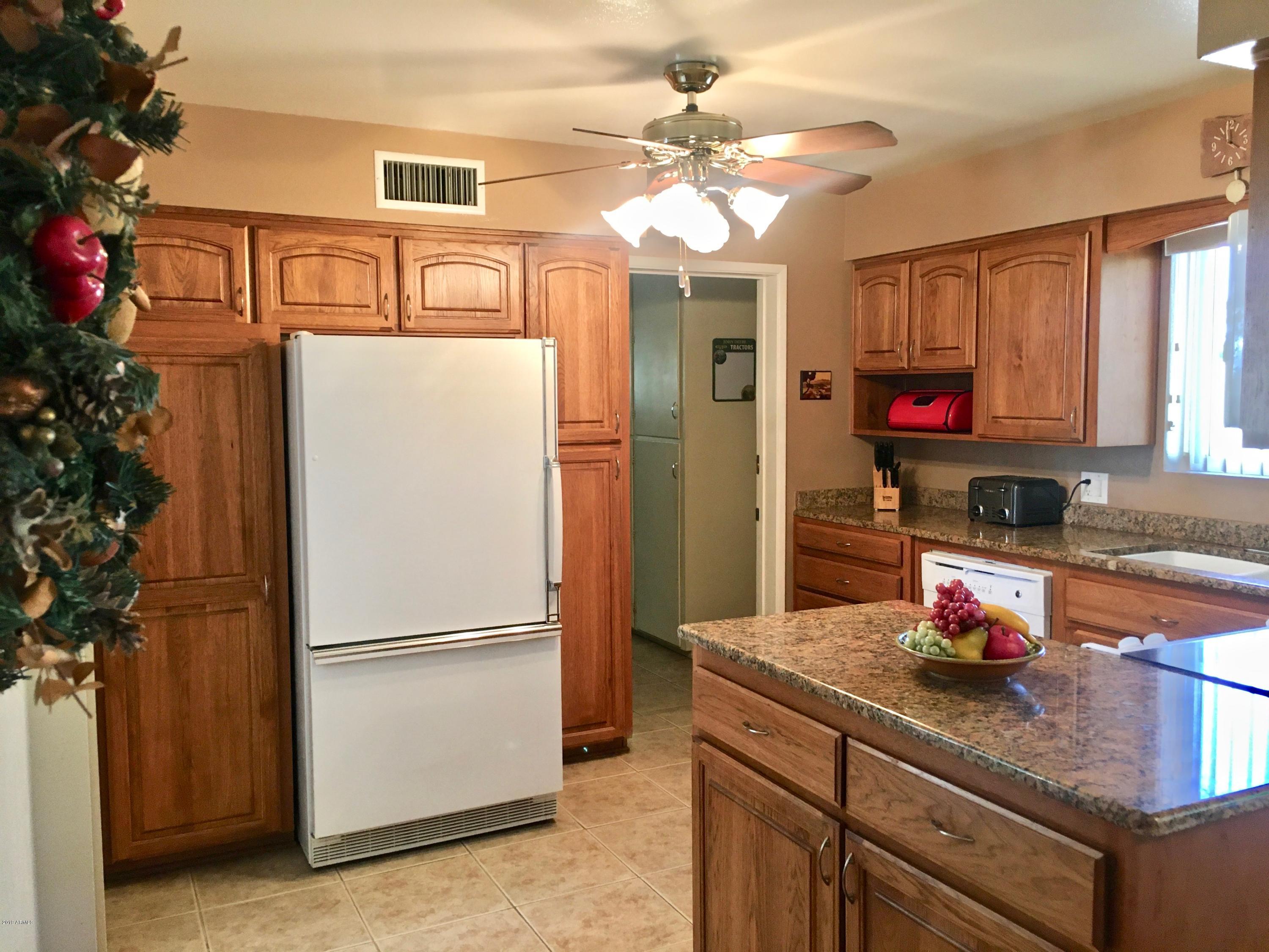 5402 East Decatur Street Mesa, AZ 85205 - Photo 9 of 37 a kitchen with stainless steel appliances granite countertop a refrigerator and a stove