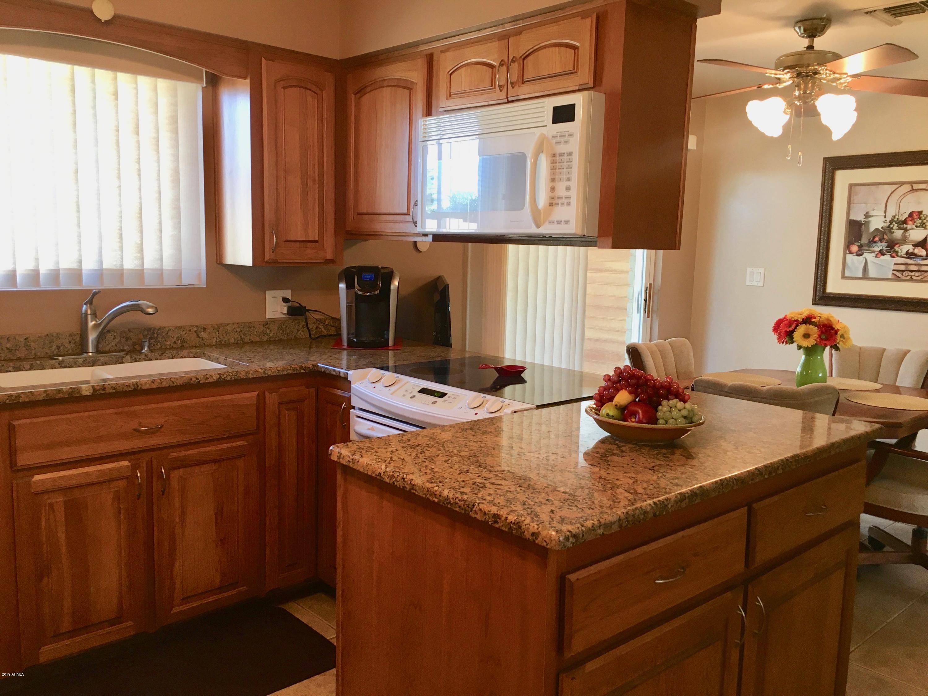5402 East Decatur Street Mesa, AZ 85205 - Photo 10 of 37 a kitchen with sink cabinets and window