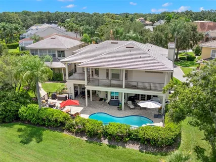 an aerial view of a house with a garden and lake view