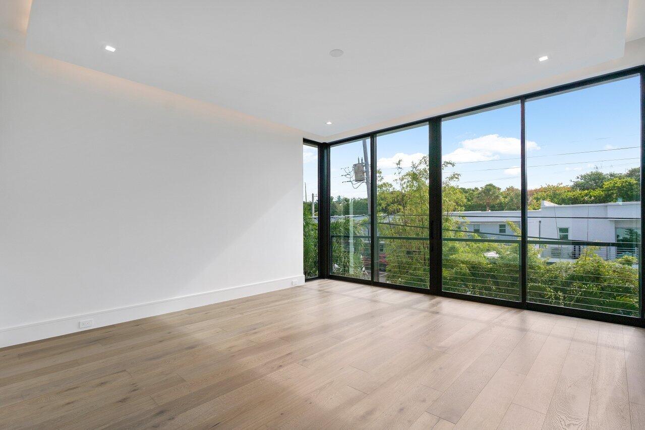320 Northeast Wavecrest Way Boca Raton, FL 33432 - Photo 15 of 48 wooden floor in an empty room with glass windows