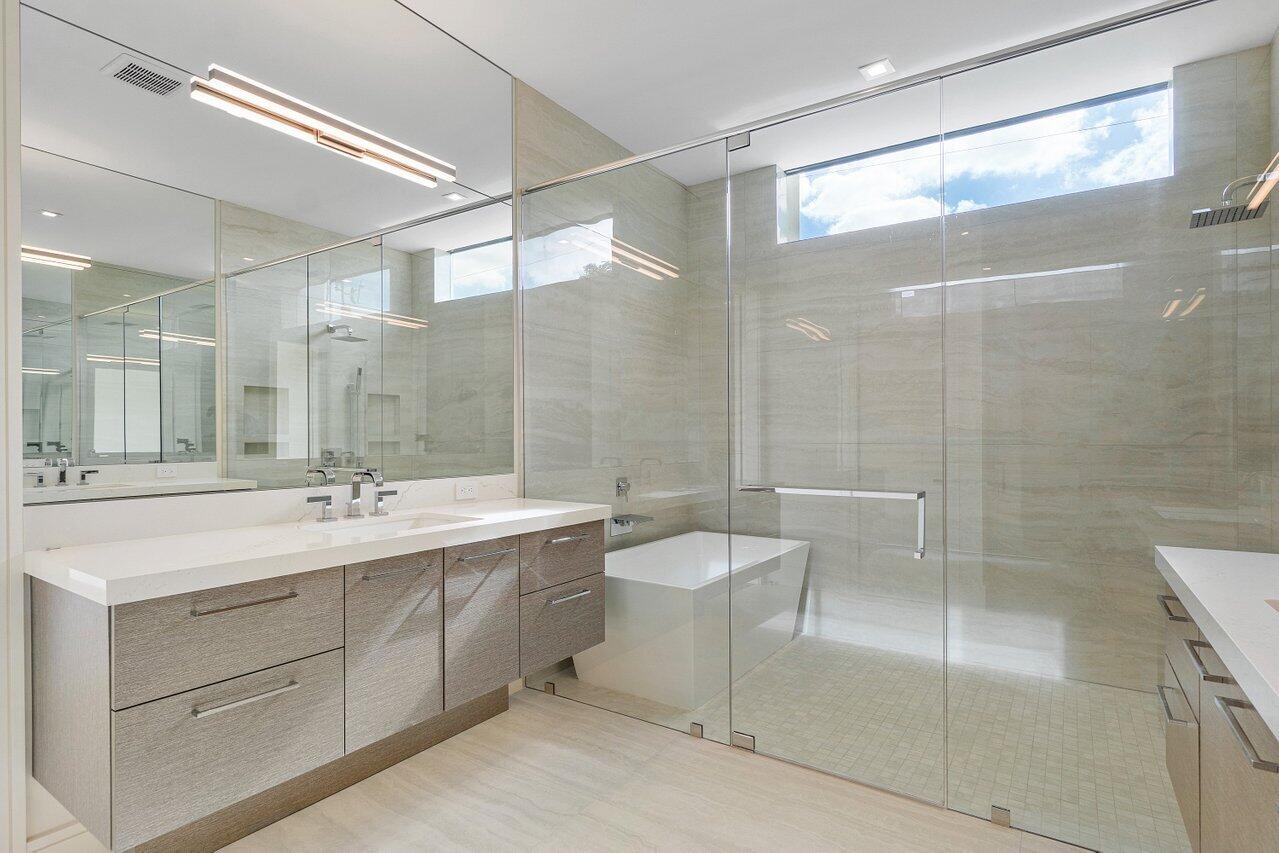 320 Northeast Wavecrest Way Boca Raton, FL 33432 - Photo 18 of 48 a bathroom with a double vanity sink mirror and shower