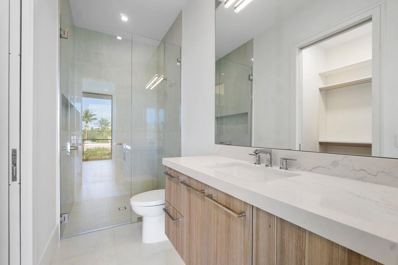 320 Northeast Wavecrest Way Boca Raton, FL 33432 - Photo 23 of 48 a bathroom with a sink a toilet and shower