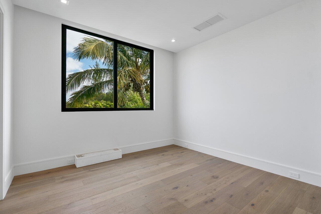 320 Northeast Wavecrest Way Boca Raton, FL 33432 - Photo 25 of 48 an empty room with wooden floor and large window