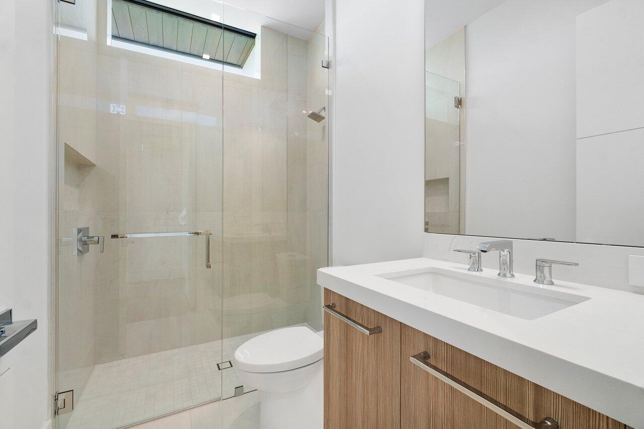 320 Northeast Wavecrest Way Boca Raton, FL 33432 - Photo 26 of 48 a bathroom with a sink a toilet and shower