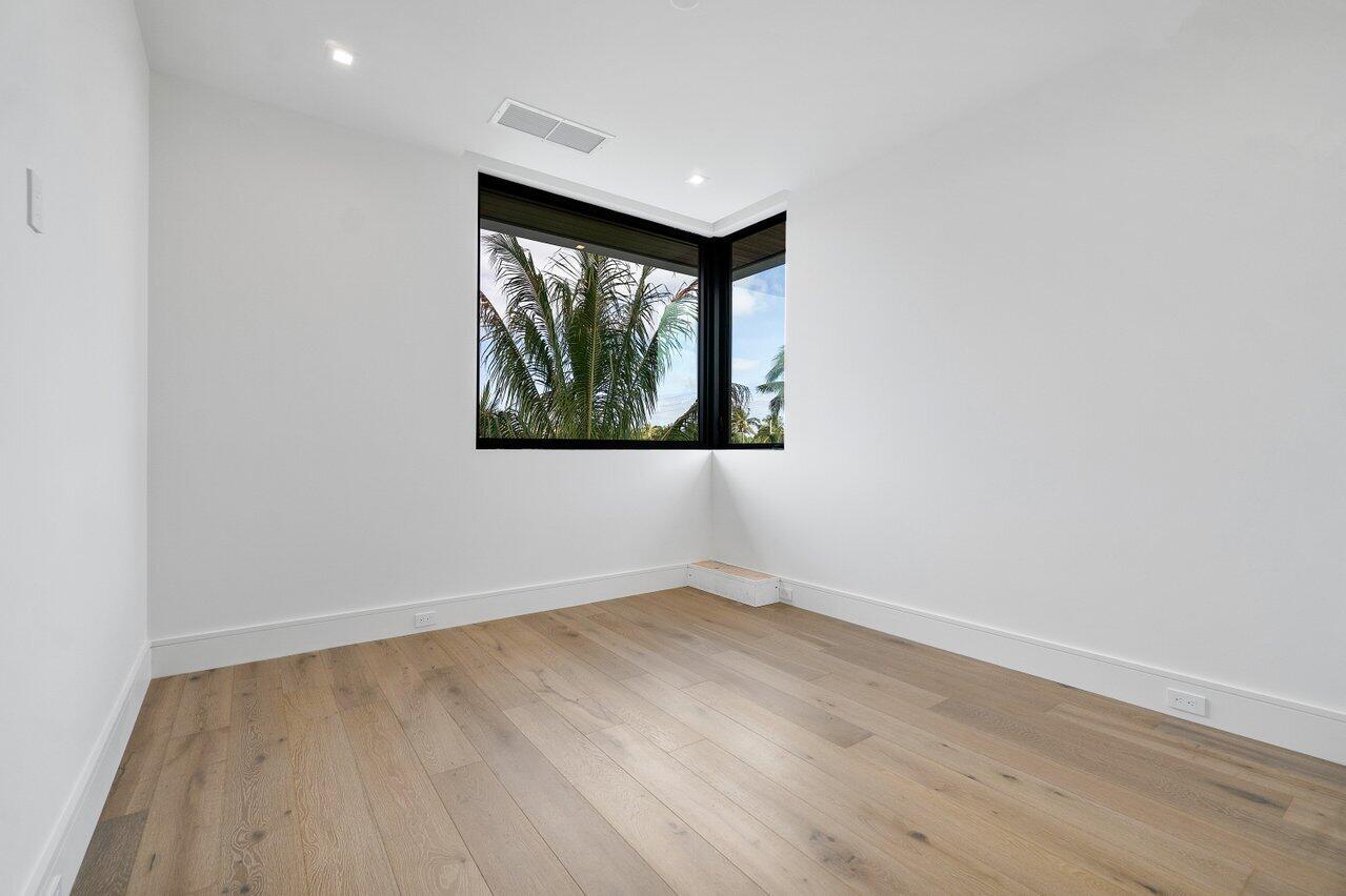 320 Northeast Wavecrest Way Boca Raton, FL 33432 - Photo 27 of 48 an empty room with wooden floor and windows