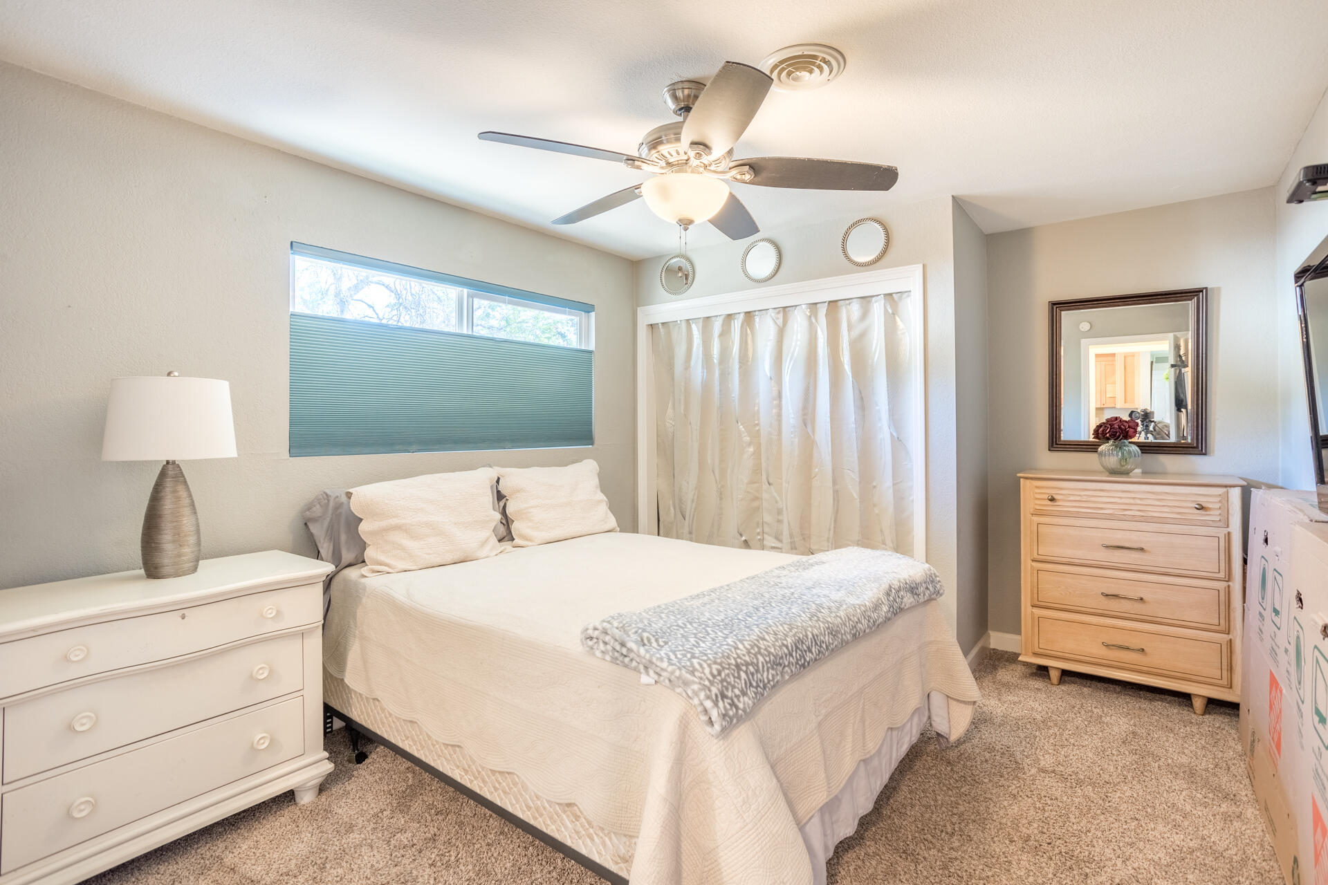 2766 Robert Court Redding, CA 96002 - Photo 11 of 28 a bedroom with a bed a chandelier and a mirror