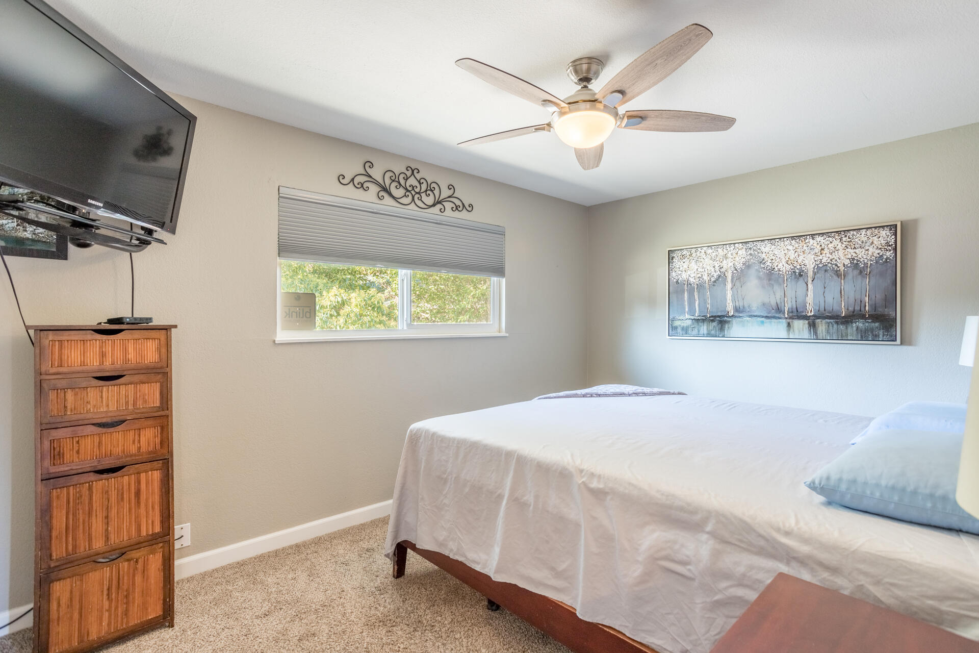 2766 Robert Court Redding, CA 96002 - Photo 15 of 28 a bedroom with a large bed a chandelier and a window