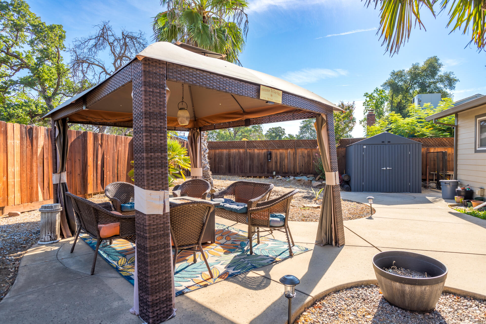 2766 Robert Court Redding, CA 96002 - Photo 18 of 28 a view of a patio with a dining table and chairs under an umbrella