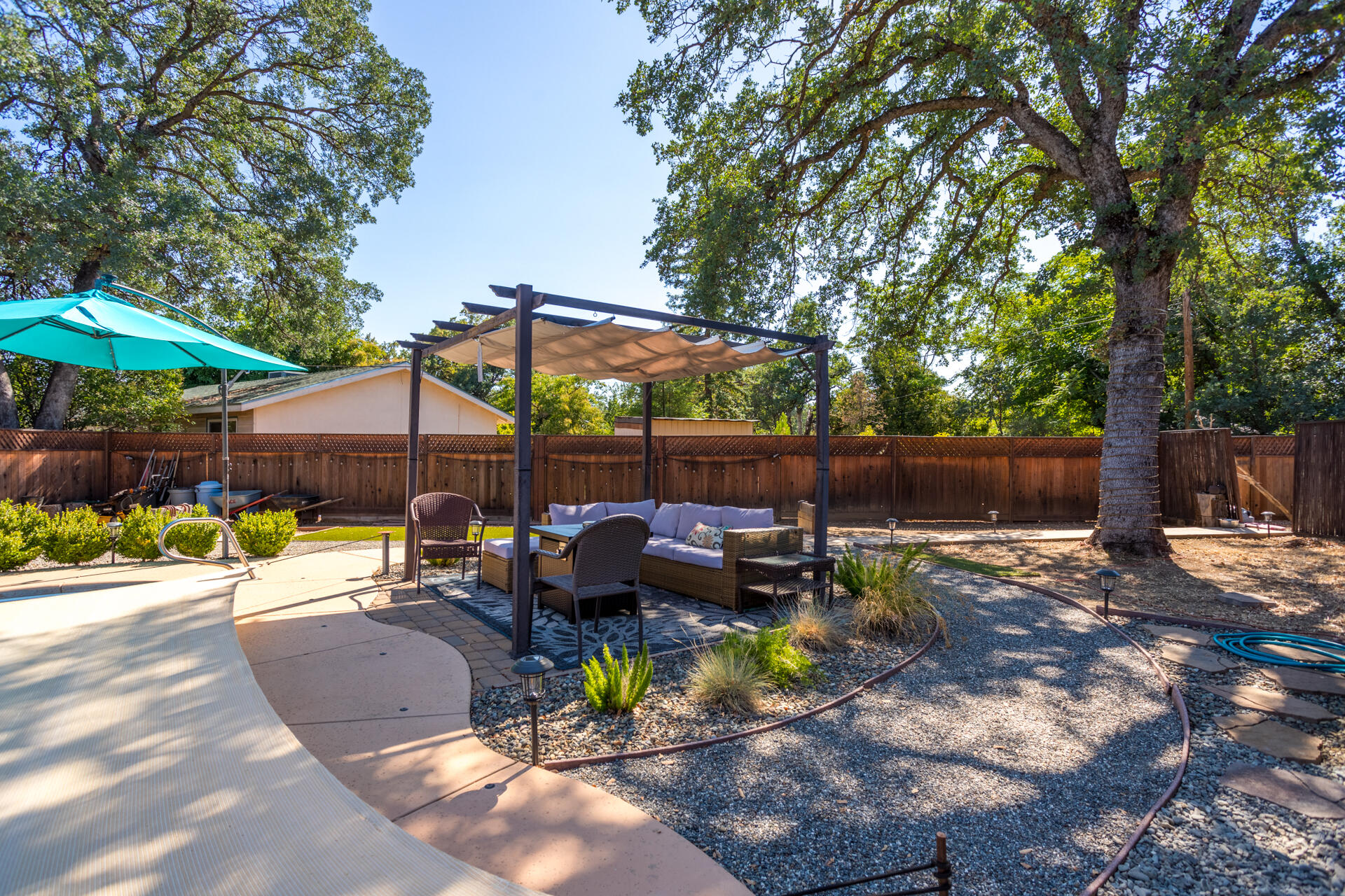 2766 Robert Court Redding, CA 96002 - Photo 20 of 28 a view of backyard with outdoor seating and trees