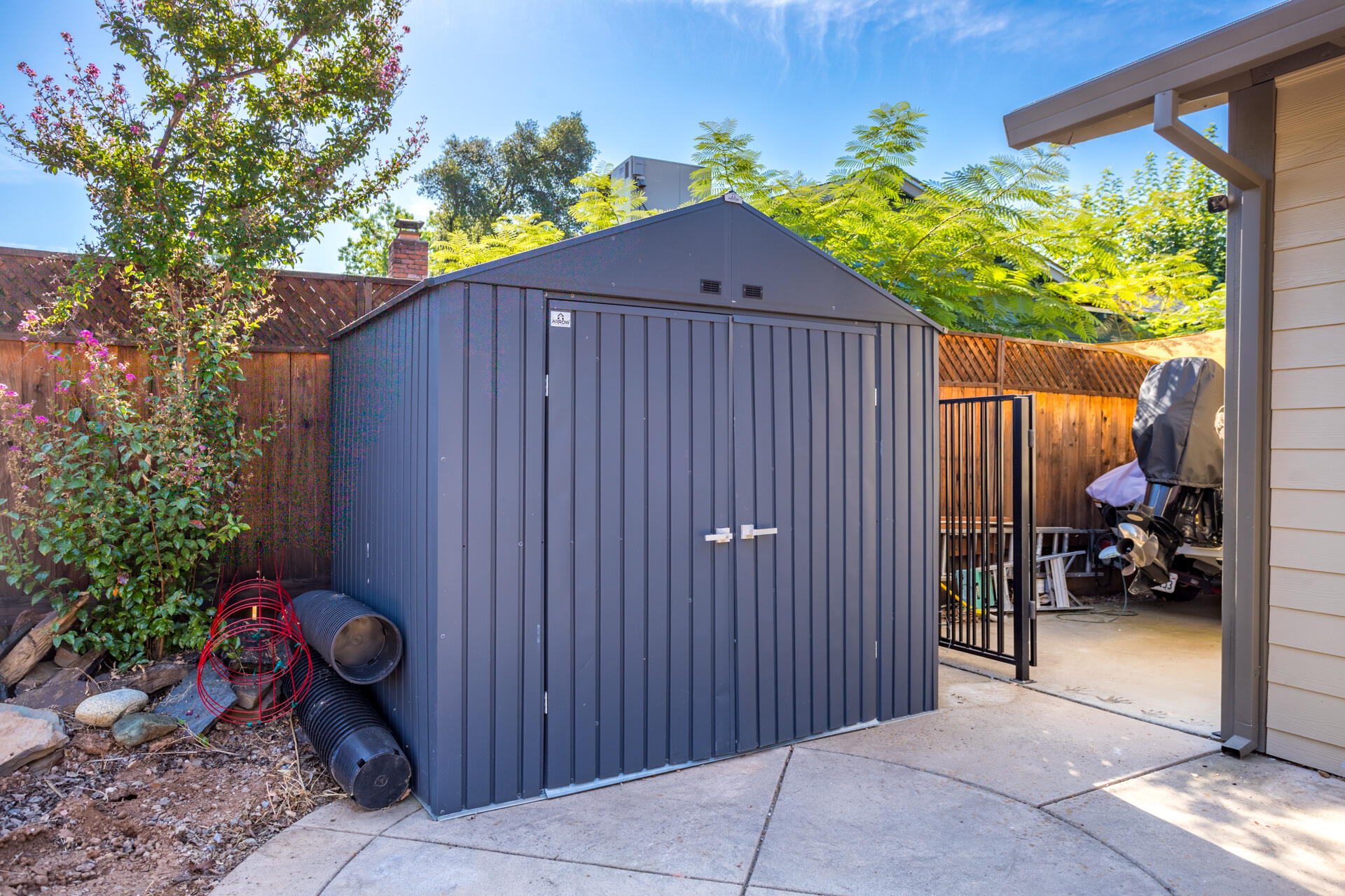 2766 Robert Court Redding, CA 96002 - Photo 21 of 28 a backyard of a house with potted plants and covered with wooden fence
