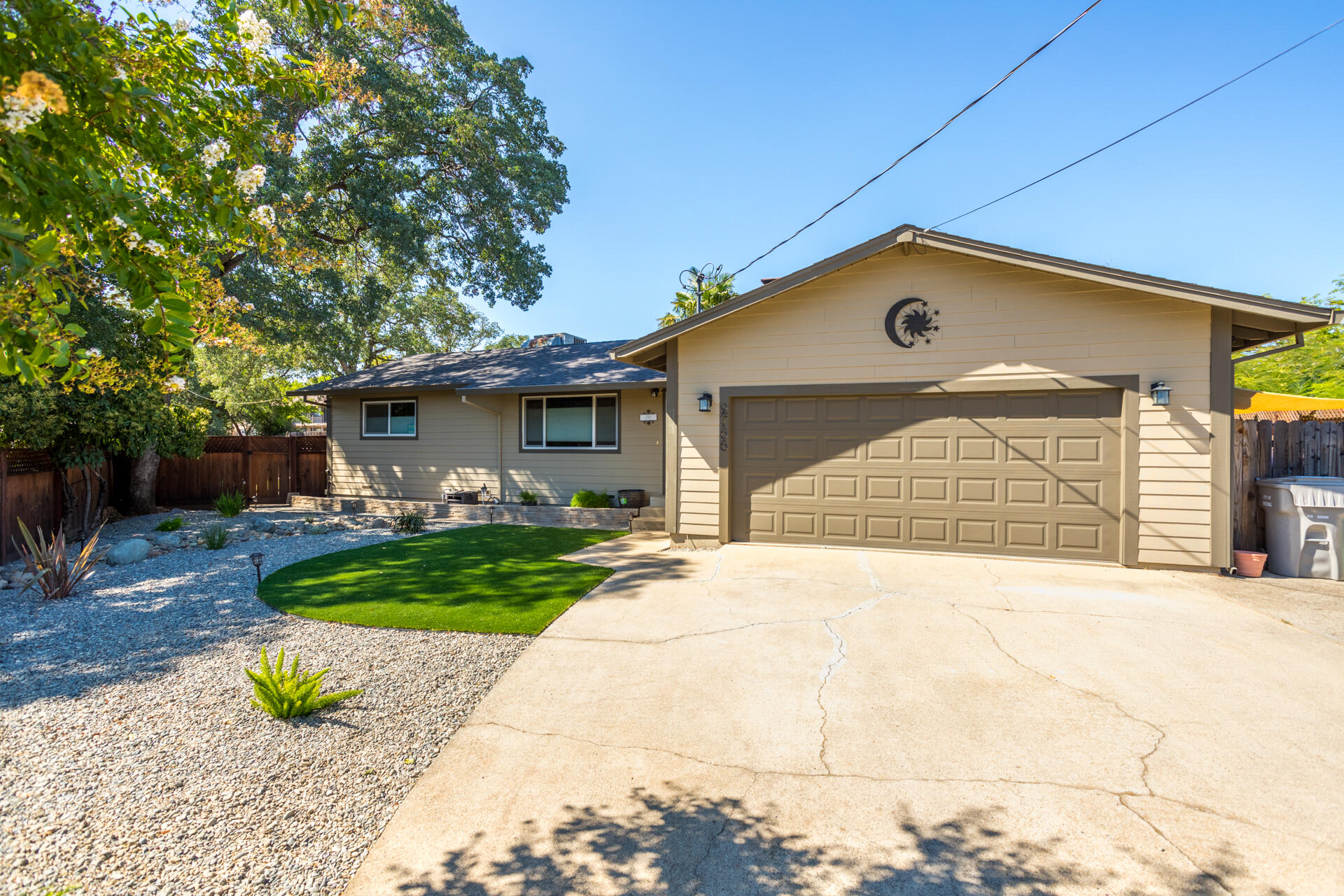 2766 Robert Court Redding, CA 96002 - Photo 22 of 28 a front view of a house with a yard and garage