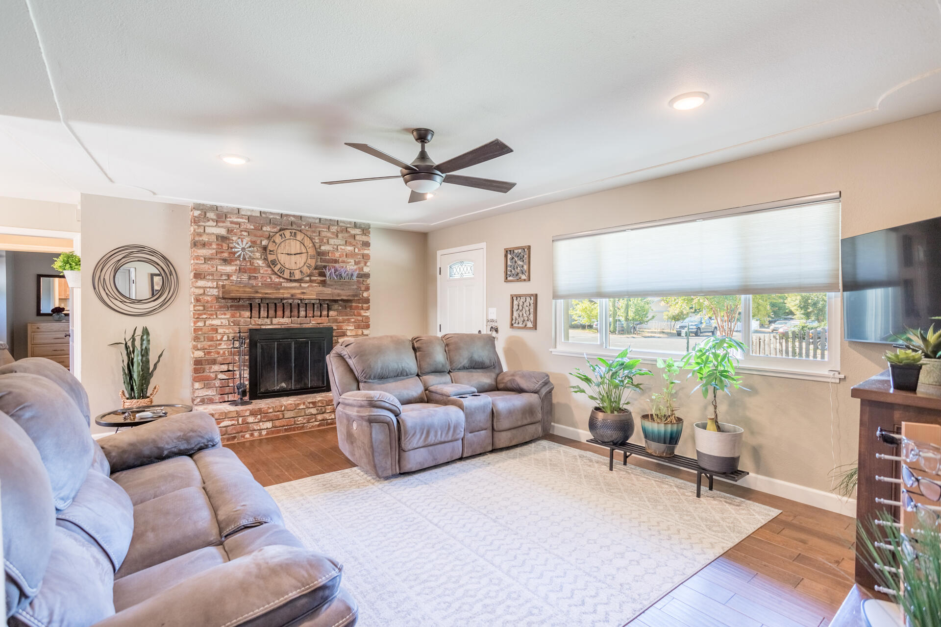 2766 Robert Court Redding, CA 96002 - Photo 4 of 28 a living room with furniture a fireplace and a large window