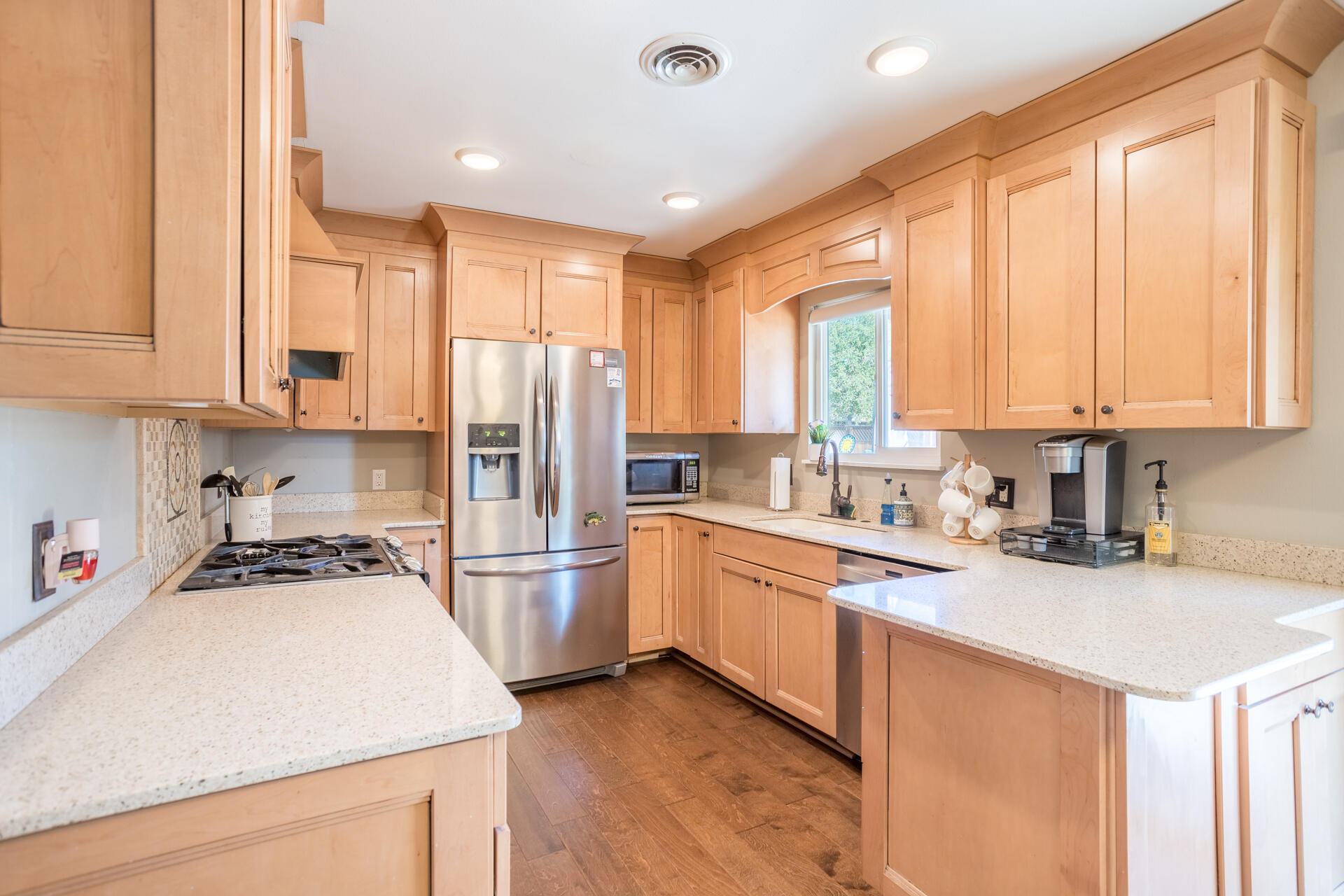 2766 Robert Court Redding, CA 96002 - Photo 5 of 28 a kitchen with stainless steel appliances granite countertop a refrigerator a sink dishwasher a stove and white countertops with wooden floor