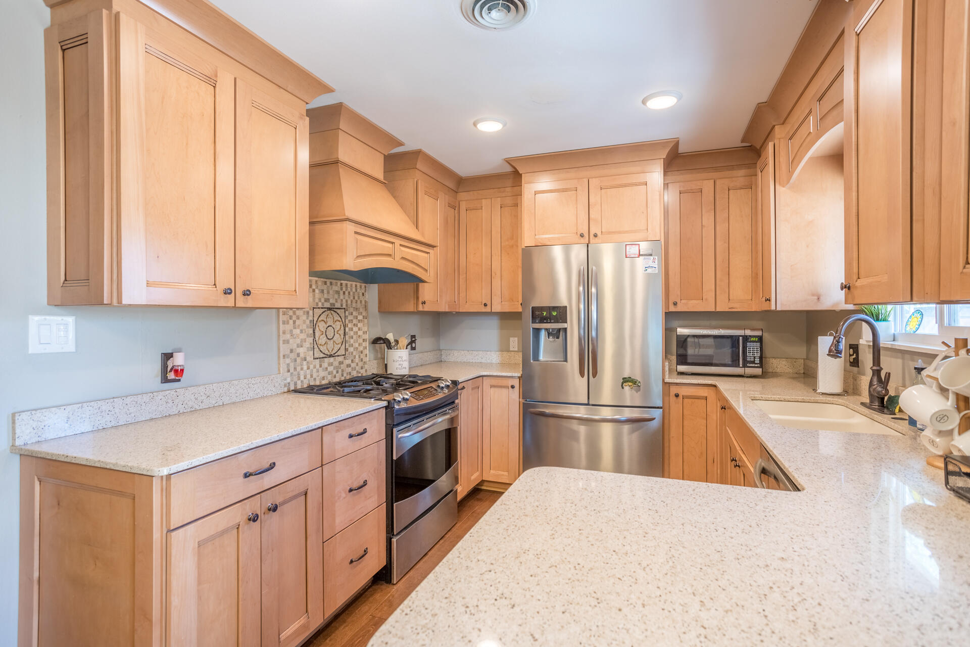 2766 Robert Court Redding, CA 96002 - Photo 6 of 28 a kitchen with stainless steel appliances granite countertop a refrigerator a sink dishwasher a stove and white countertops with wooden floor