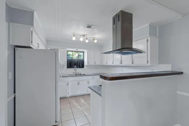a kitchen with a sink cabinets and window