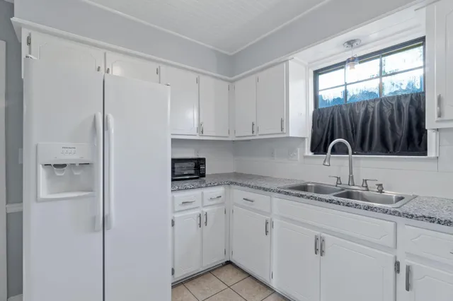 a kitchen with cabinets and steel stainless steel appliances