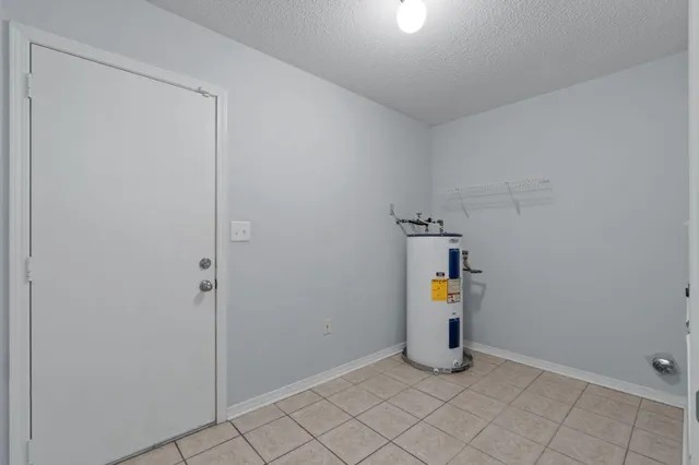 an empty room with closet and a chandelier fan