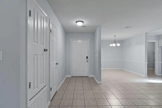 a view of an empty room with a fireplace and a window
