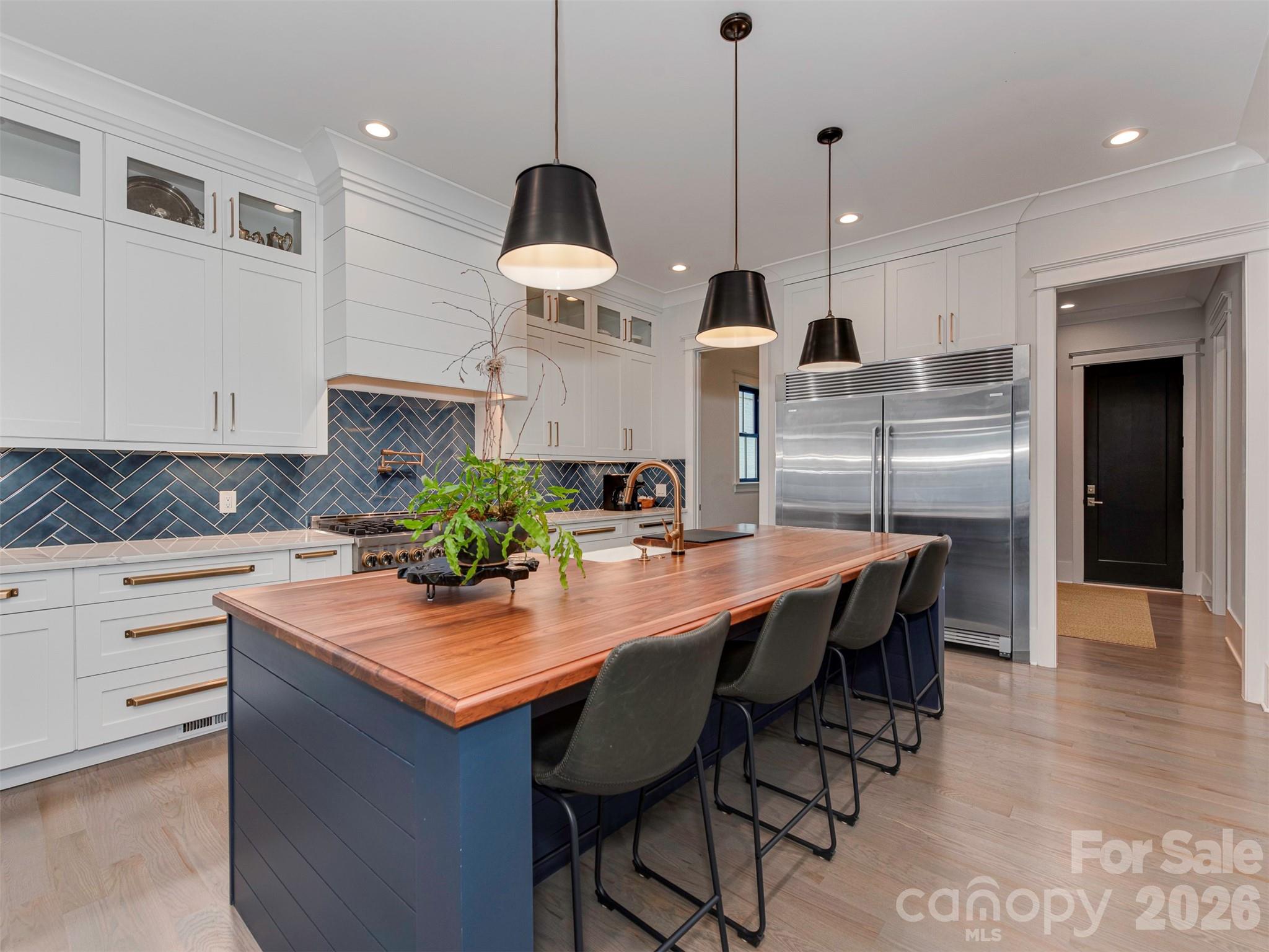 4009 Ridgecrest Avenue Charlotte, NC 28211 - Photo 12 of 43 a kitchen with stainless steel appliances granite countertop a sink a stove a dining table and chairs