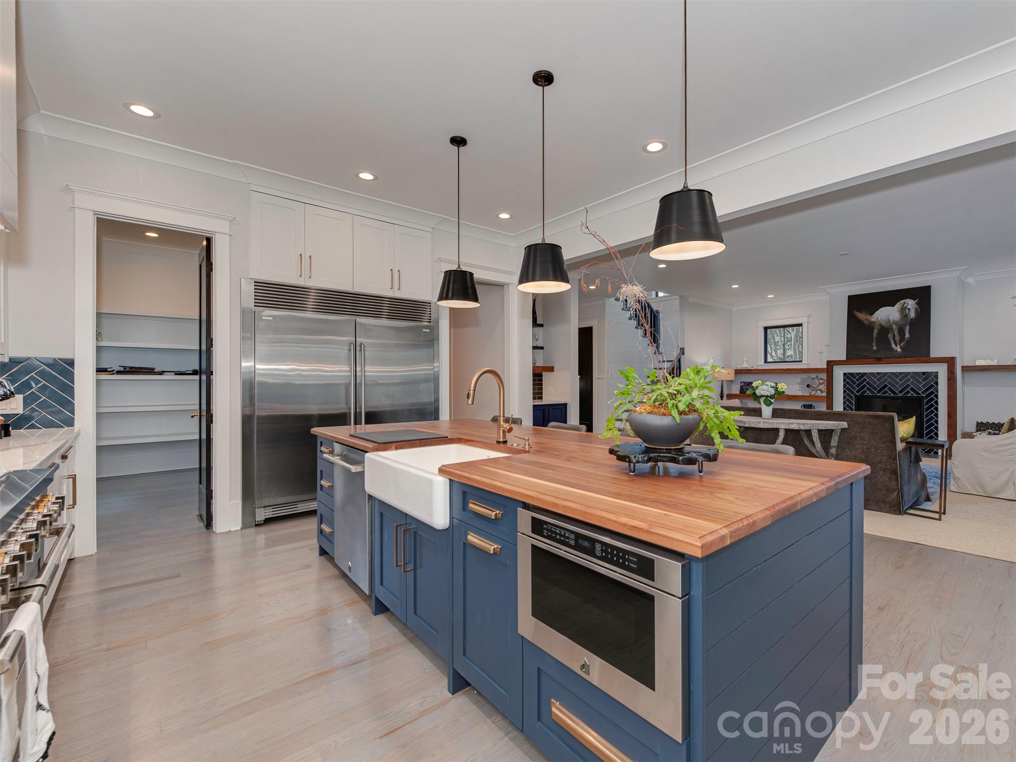 4009 Ridgecrest Avenue Charlotte, NC 28211 - Photo 14 of 43 a kitchen with stainless steel appliances granite countertop a stove and a refrigerator