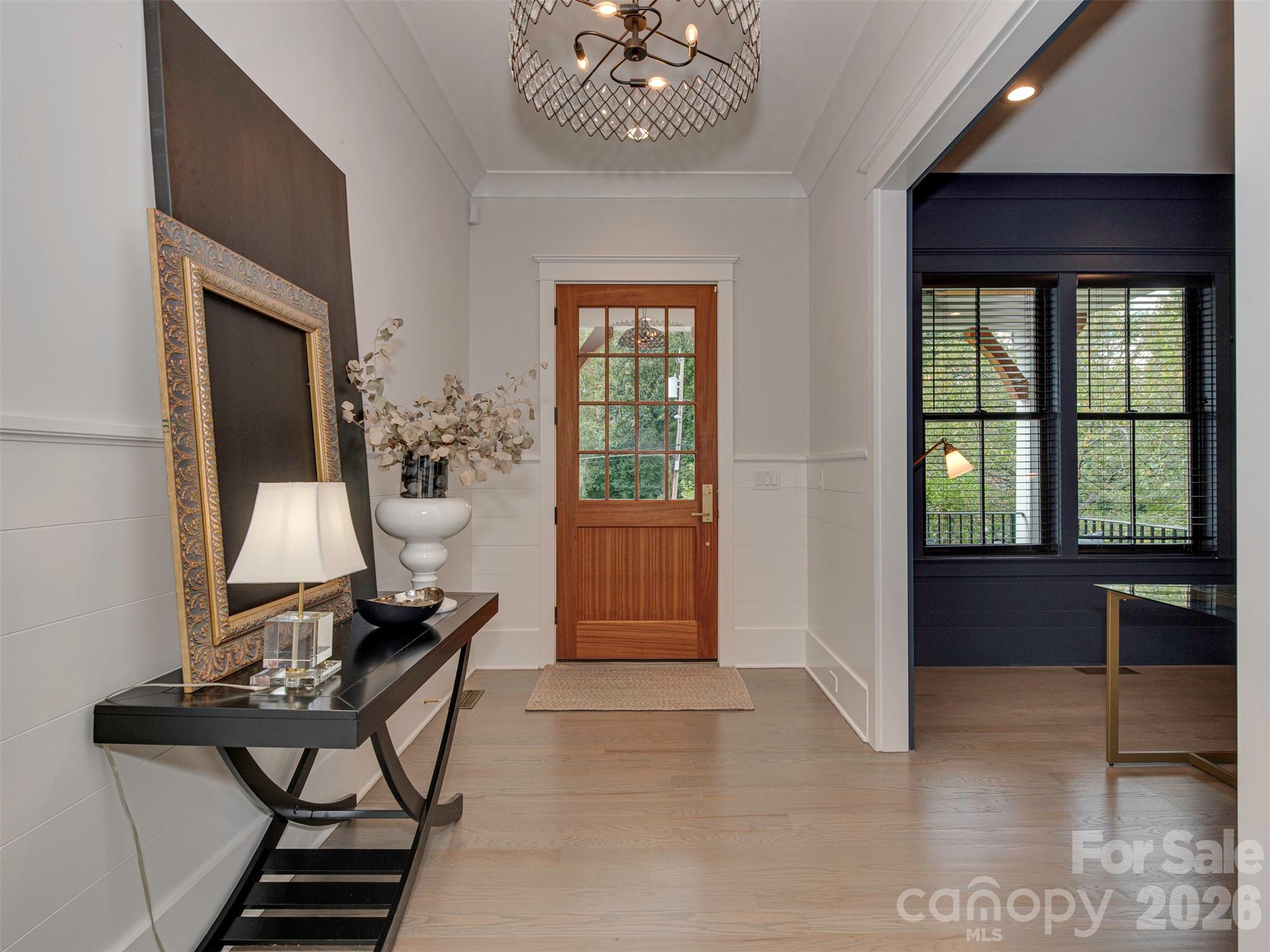 4009 Ridgecrest Avenue Charlotte, NC 28211 - Photo 2 of 43 a living room with furniture a window and a chandelier
