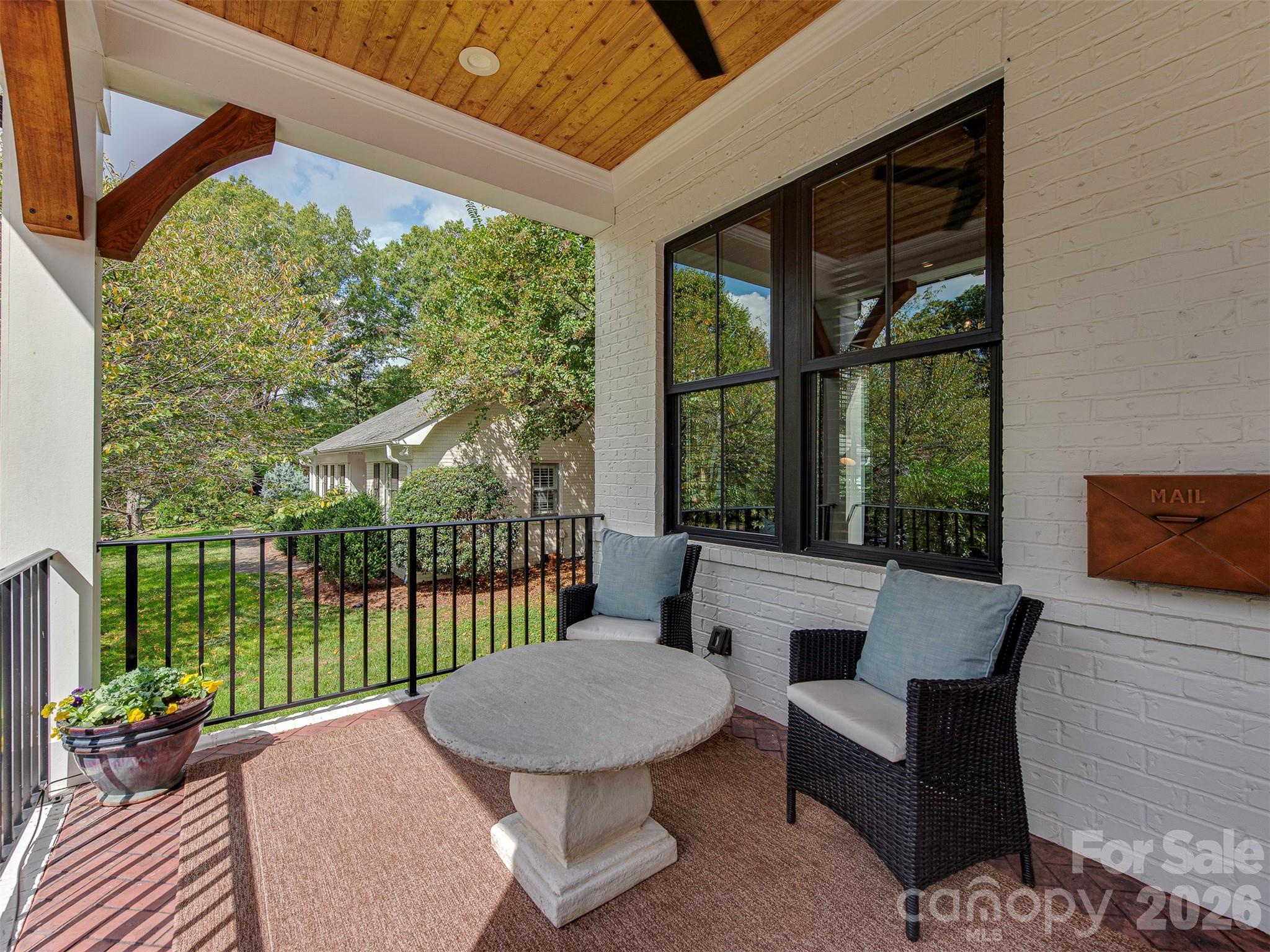 4009 Ridgecrest Avenue Charlotte, NC 28211 - Photo 3 of 43 a view of a patio with a table chairs and a backyard
