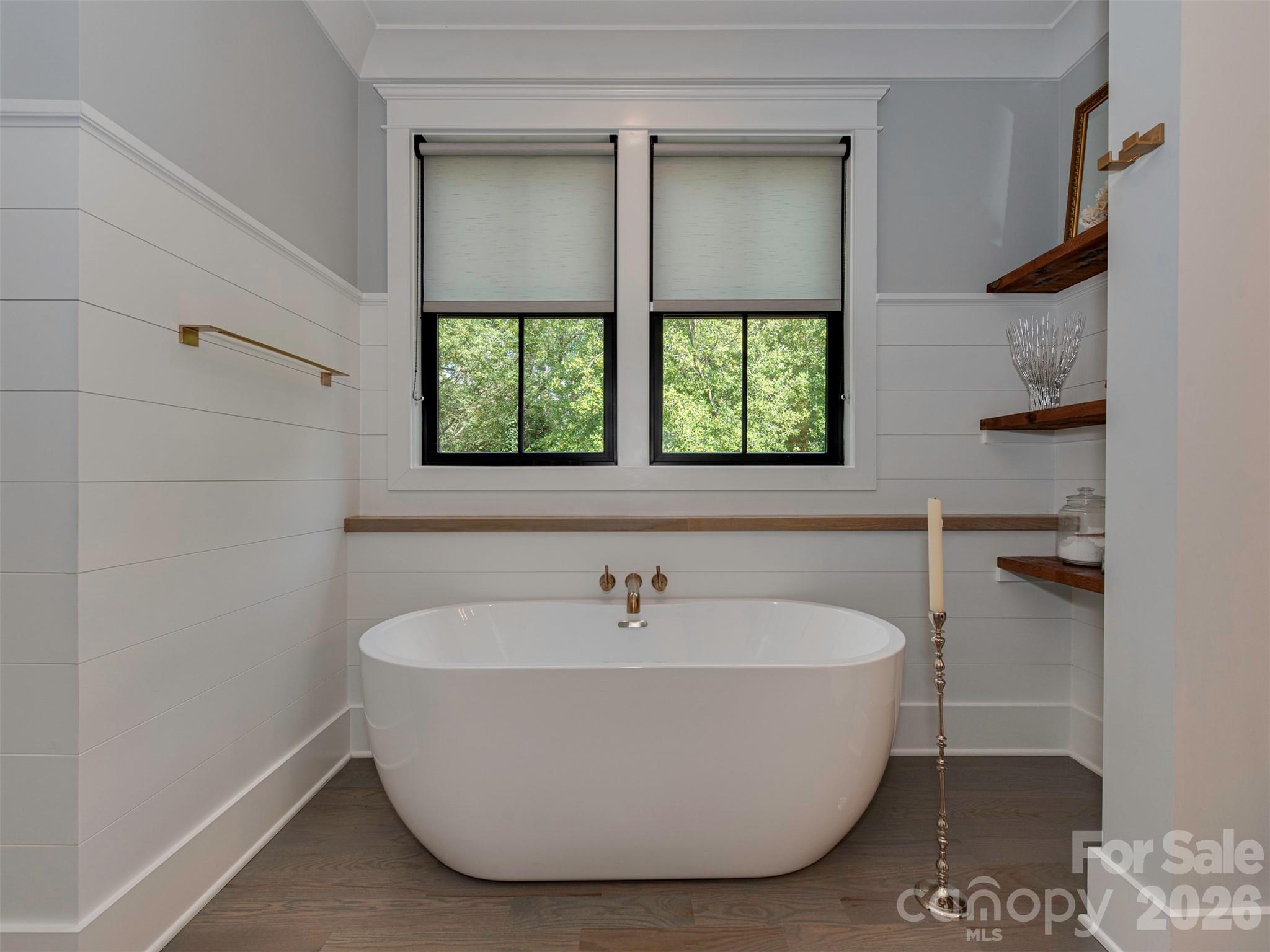 4009 Ridgecrest Avenue Charlotte, NC 28211 - Photo 37 of 43 a white bath tub sitting in a bathroom next to a window